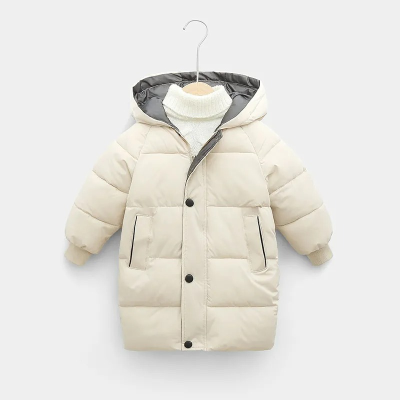 Parka enfant longue bleue rembourrée Parka enfant longue style doudoune, beige clair avec capuche et deux poches.