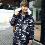 Parka militaire bleue et blanche à motifs sur un homme en extérieur